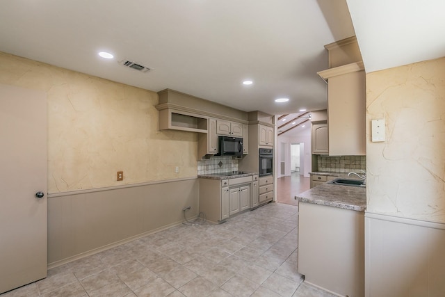 kitchen featuring light tile patterned flooring, sink, tasteful backsplash, and black appliances