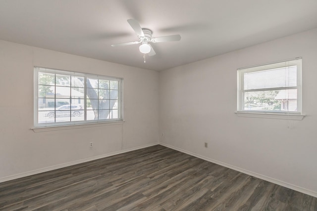 spare room with ceiling fan and dark wood-type flooring