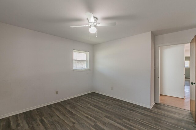 unfurnished room featuring dark hardwood / wood-style floors and ceiling fan