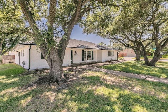 ranch-style house with a garage and a front lawn