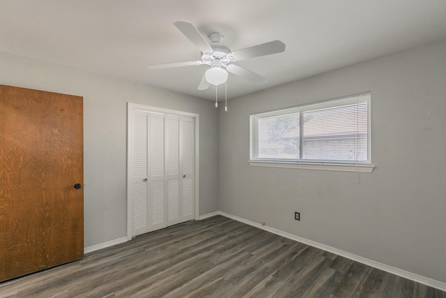 unfurnished bedroom featuring a closet, ceiling fan, and dark hardwood / wood-style flooring