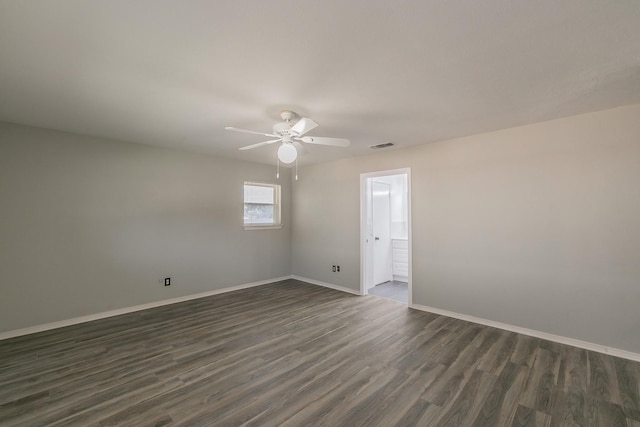 spare room featuring dark hardwood / wood-style flooring and ceiling fan