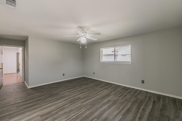 unfurnished room with ceiling fan and dark wood-type flooring