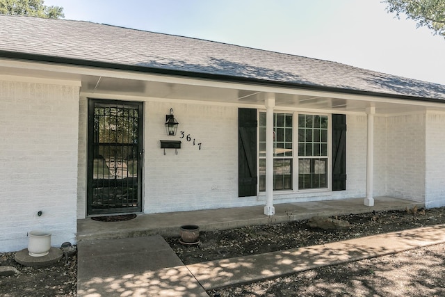 view of exterior entry featuring a porch