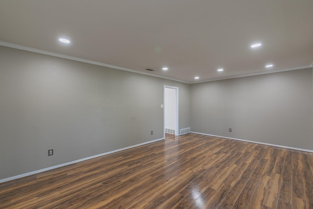 spare room featuring dark hardwood / wood-style floors and ornamental molding