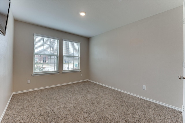 unfurnished room featuring carpet