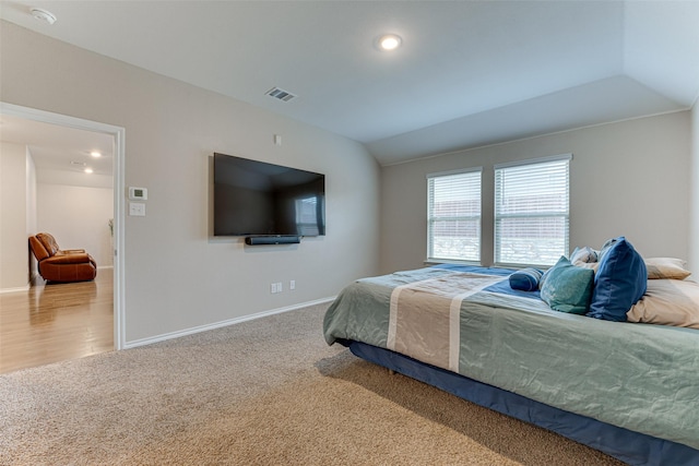 bedroom with carpet flooring and lofted ceiling