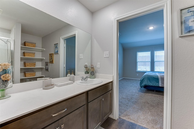 bathroom with hardwood / wood-style floors and vanity