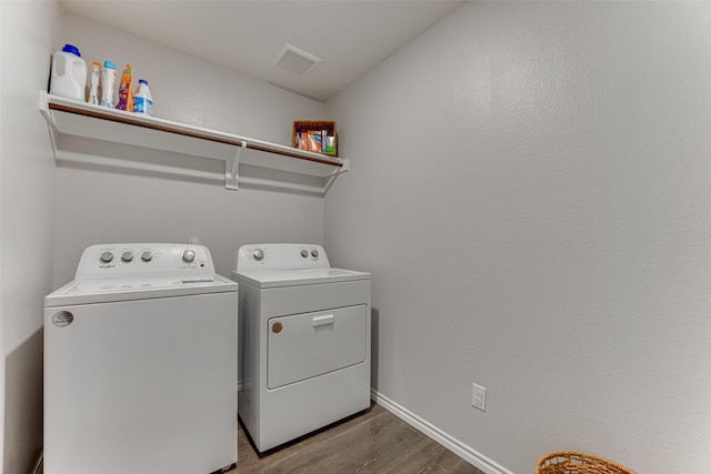 clothes washing area featuring independent washer and dryer and hardwood / wood-style floors