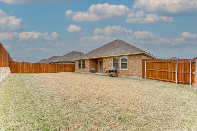 back of house featuring a lawn