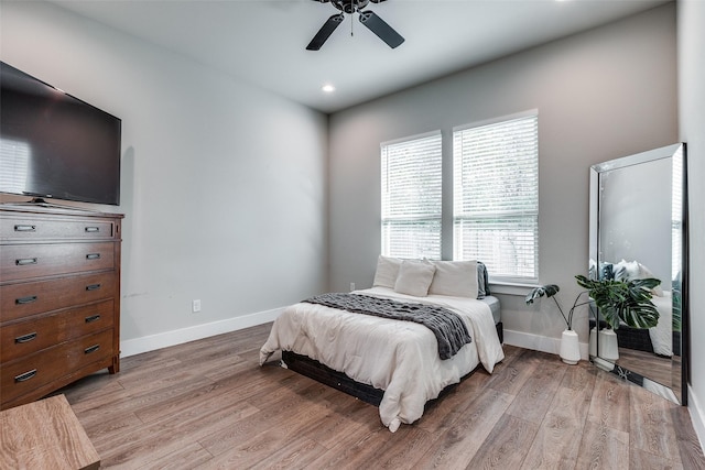 bedroom with light wood-type flooring and ceiling fan