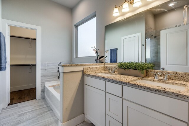 bathroom with shower with separate bathtub and vanity