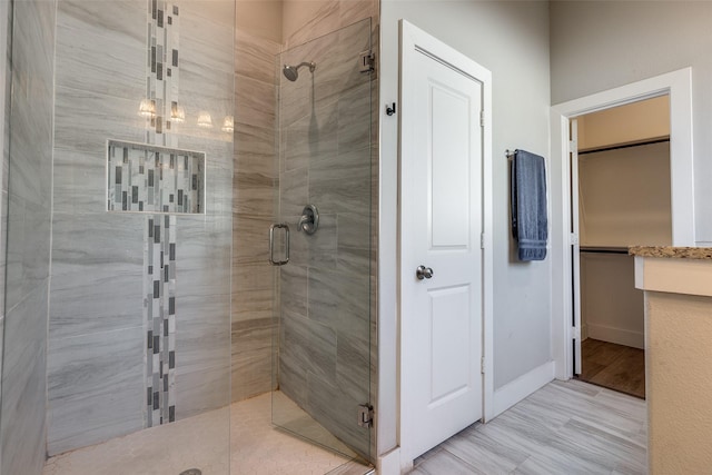 bathroom with wood-type flooring and walk in shower