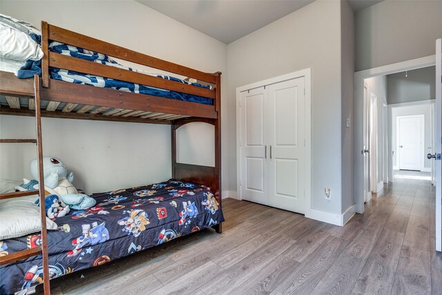 bedroom with a closet and light hardwood / wood-style flooring