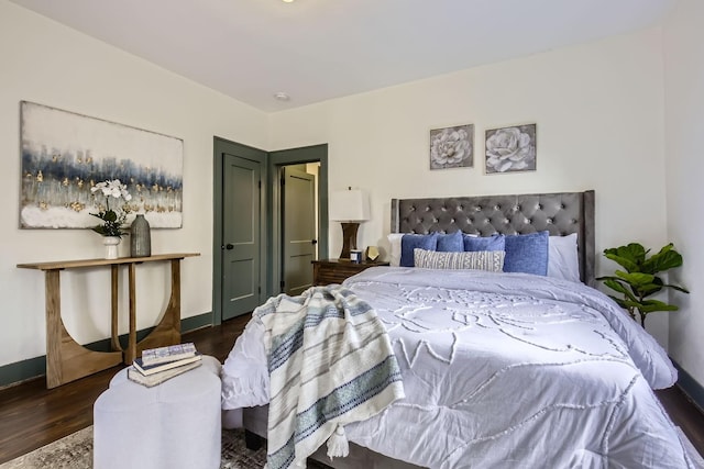 bedroom with dark wood-type flooring