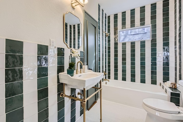 bathroom featuring toilet, tile walls, and a tub