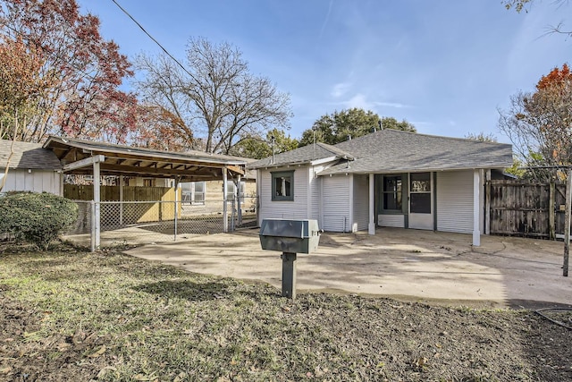 back of property featuring a carport