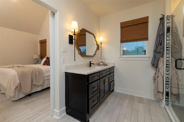 bathroom with a shower with door, vanity, wood-type flooring, and lofted ceiling