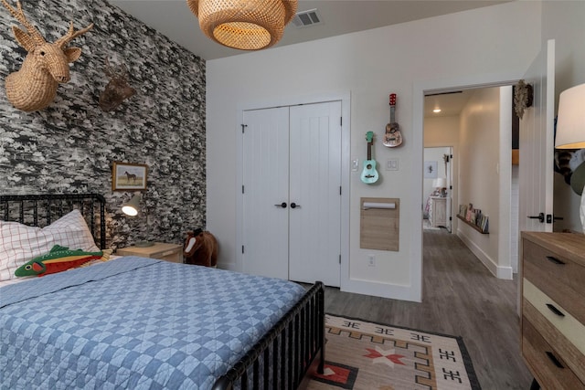 bedroom featuring a closet and dark hardwood / wood-style flooring