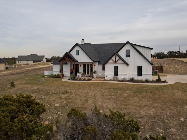 modern inspired farmhouse with a front lawn