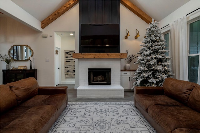 living room with beam ceiling, a fireplace, high vaulted ceiling, and light hardwood / wood-style flooring