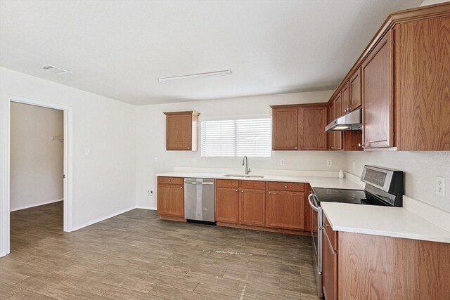 kitchen featuring sink, wood-type flooring, and appliances with stainless steel finishes