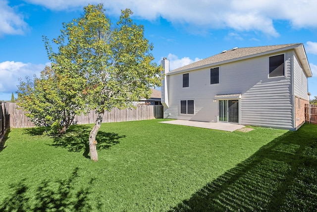 back of property with a patio area and a yard