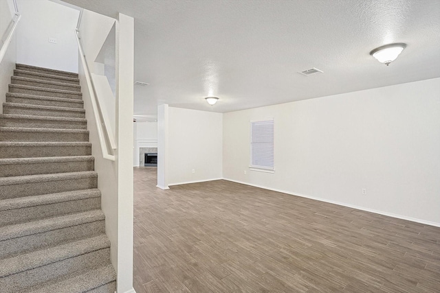 basement with dark hardwood / wood-style floors and a textured ceiling