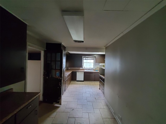 kitchen with dishwasher, ornamental molding, and sink