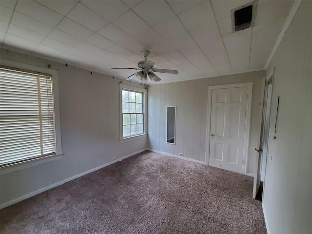 unfurnished room featuring ceiling fan and carpet floors