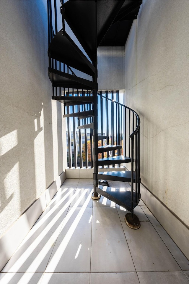 staircase with concrete flooring