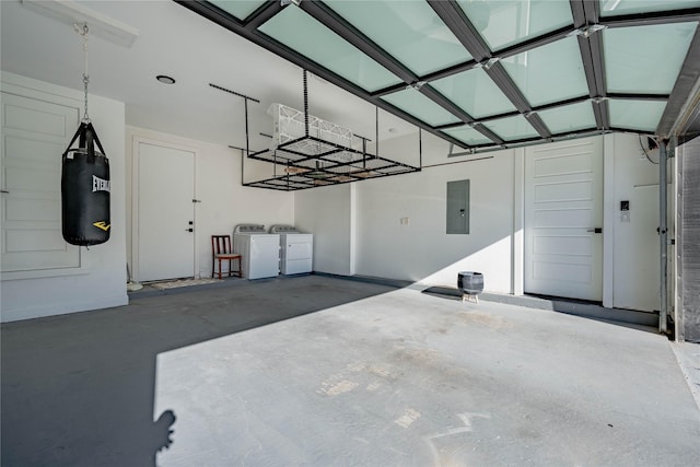 garage featuring independent washer and dryer and electric panel