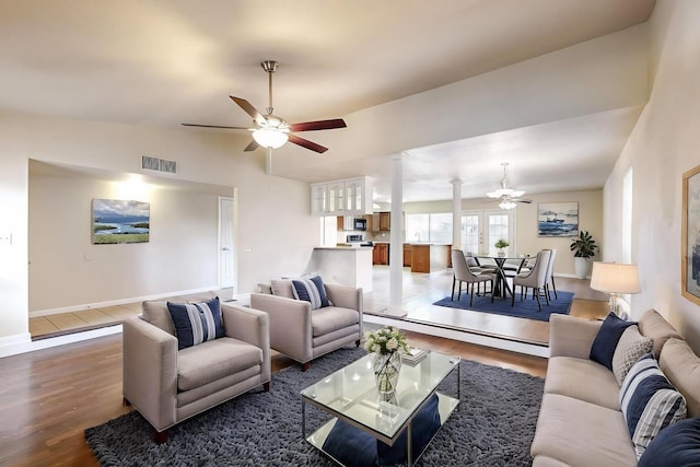 living room with dark hardwood / wood-style flooring, ceiling fan, and lofted ceiling