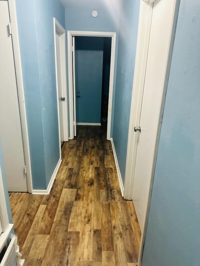 corridor featuring dark hardwood / wood-style floors