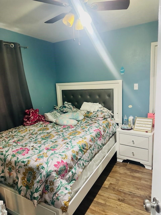 bedroom with ceiling fan and wood-type flooring