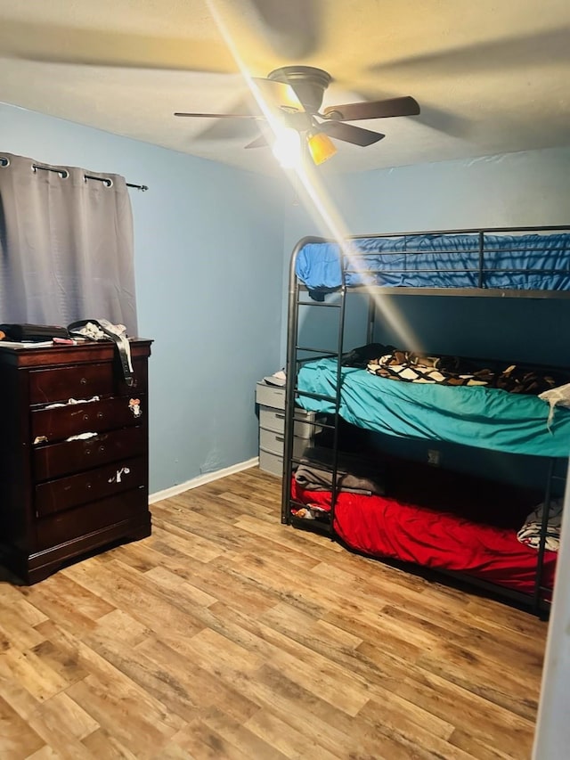 bedroom with hardwood / wood-style floors and ceiling fan