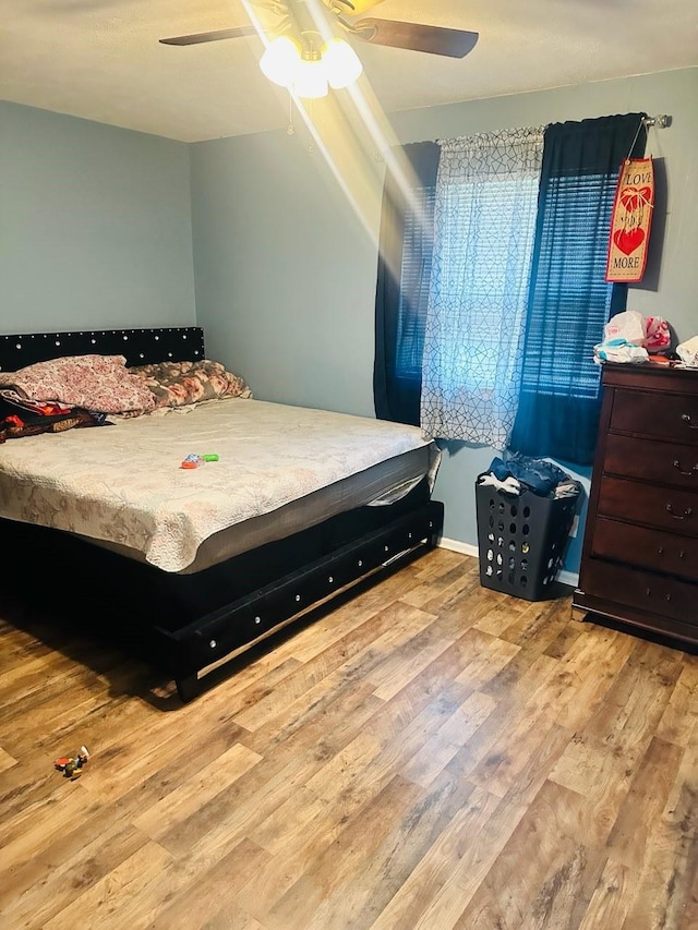 bedroom featuring light wood-type flooring and ceiling fan