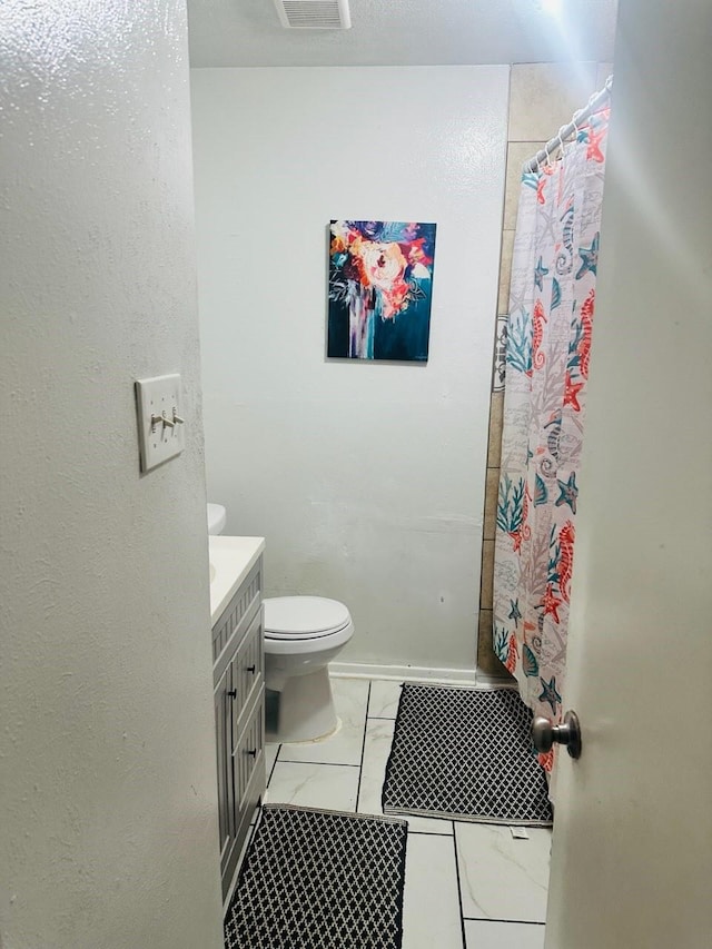 bathroom with vanity and toilet