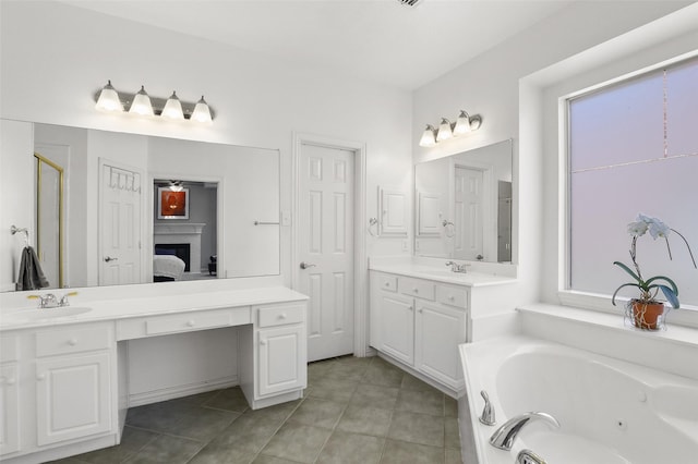 bathroom with tile patterned floors, vanity, and a bath