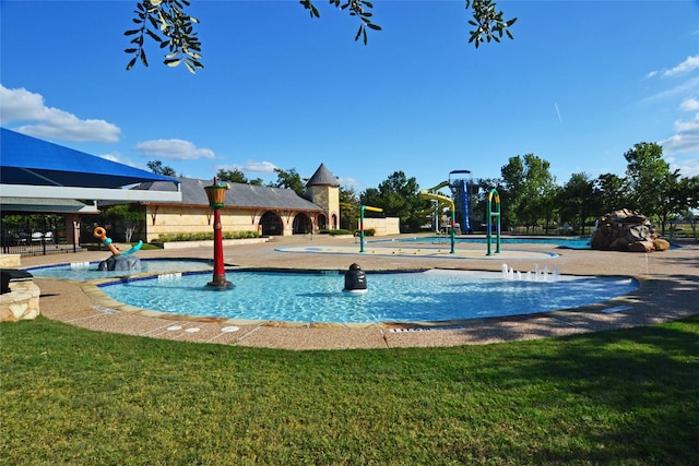 view of swimming pool featuring a playground and a yard