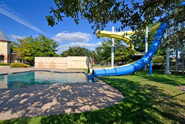 view of pool with a yard