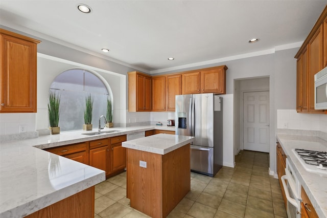 kitchen featuring light stone counters, sink, a kitchen island, and white appliances