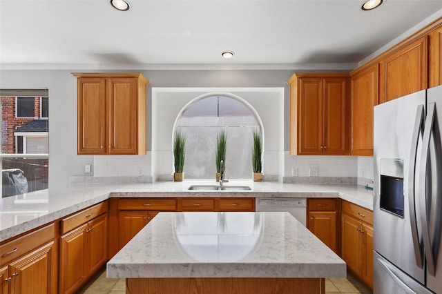 kitchen with dishwasher, stainless steel refrigerator with ice dispenser, plenty of natural light, and sink