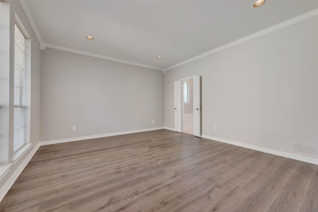 unfurnished room featuring light hardwood / wood-style flooring and ornamental molding