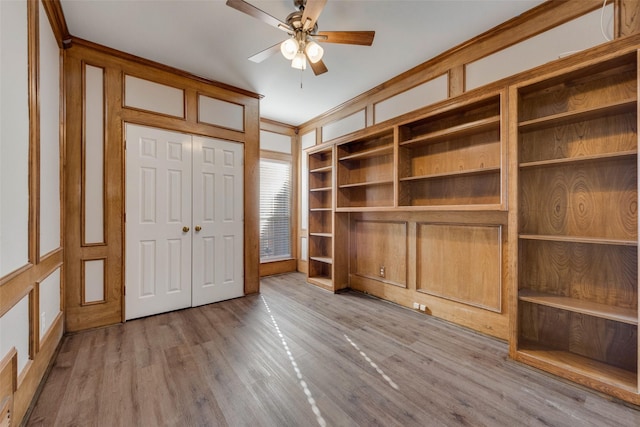 unfurnished bedroom featuring ceiling fan, crown molding, and light hardwood / wood-style floors