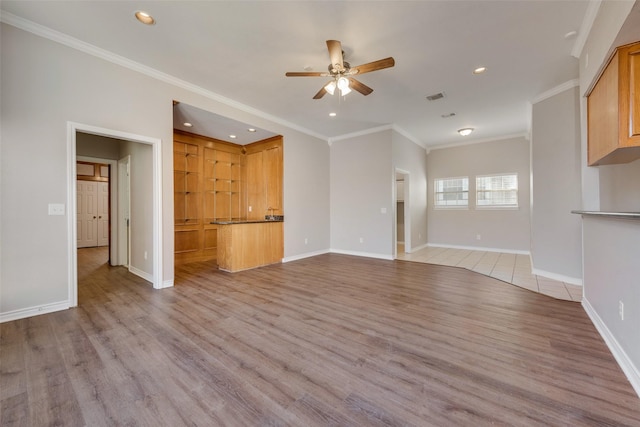 unfurnished living room featuring ceiling fan, light hardwood / wood-style floors, and ornamental molding