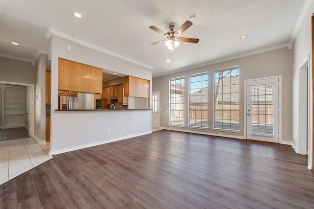 unfurnished living room featuring light wood-type flooring, ceiling fan, and ornamental molding