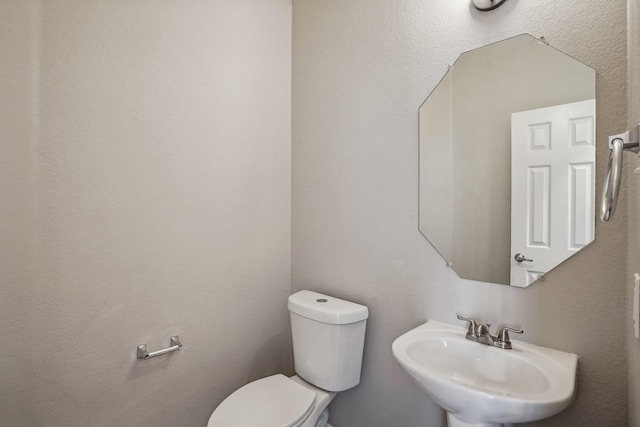 bathroom featuring sink and toilet