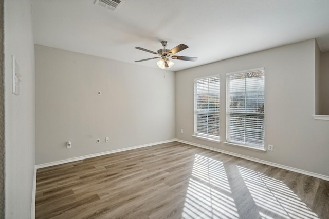 unfurnished room with hardwood / wood-style floors and ceiling fan