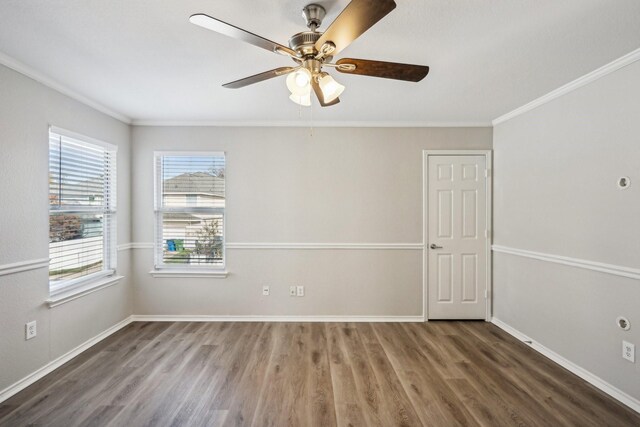 empty room with dark hardwood / wood-style flooring, ceiling fan, and crown molding